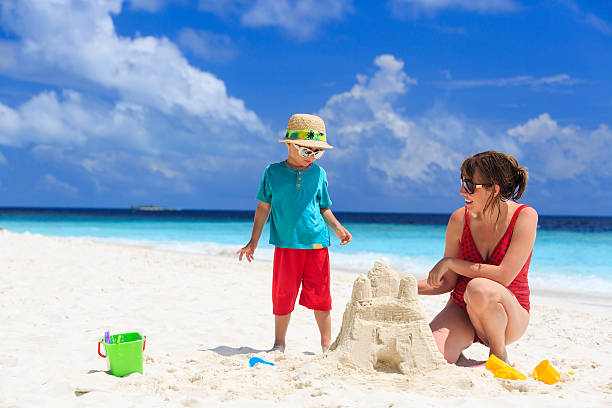 istock mother and son building castle on the beach 501278989