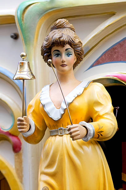 Female figure ringing a bell