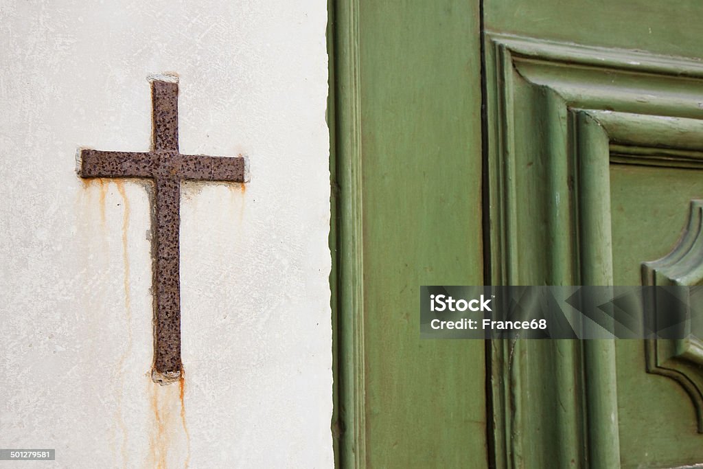 Iron cross snuggled in stone Catholicism Stock Photo