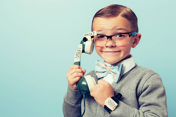 young boy nerd usando teléfono inteligente y gafas - bizarre nerd humor telephone fotografías e imágenes de stock