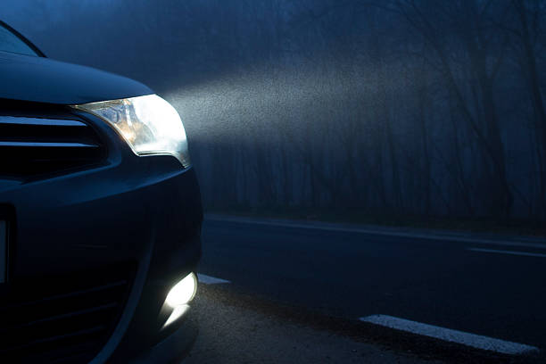 Dark Night Car Lights Headlights in the dark. headlamp stock pictures, royalty-free photos & images