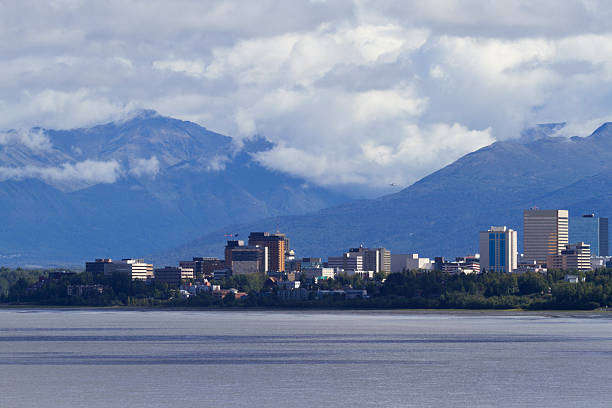 Anchorage Skyline with building signs removed Beautiful view of Anchorage skyline across Cook Inlet with rugged Chugach Mountains behind.  Building signs and logos removed. Photographed in 2015 from Woronzof Point.     chugach mountains photos stock pictures, royalty-free photos & images