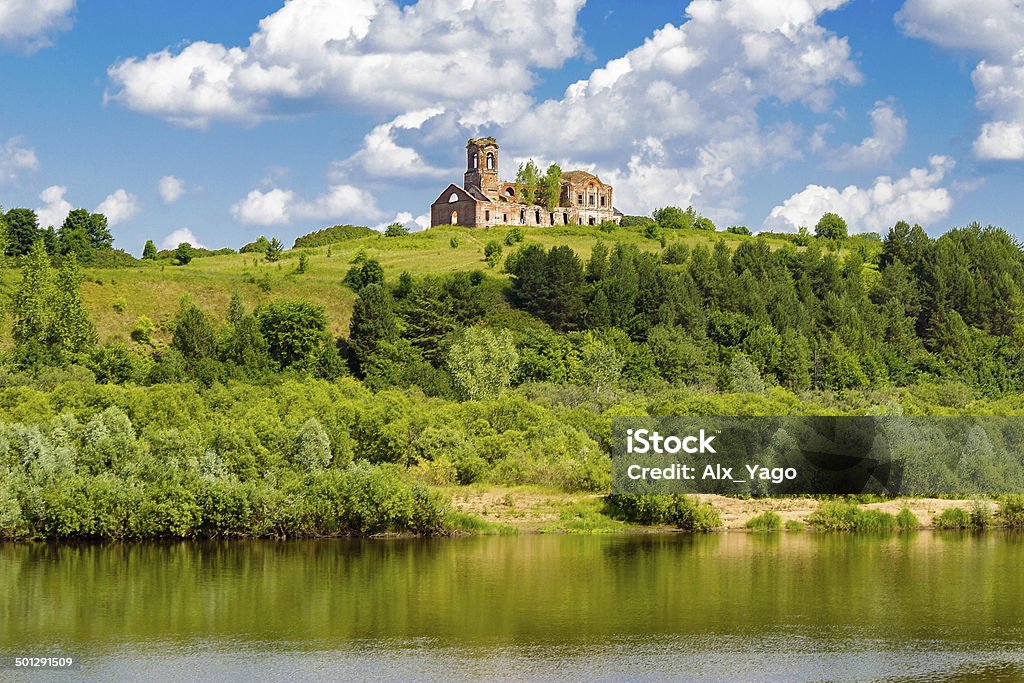 ruined church Ruined red brick church on a green hill near the river Abandoned Stock Photo
