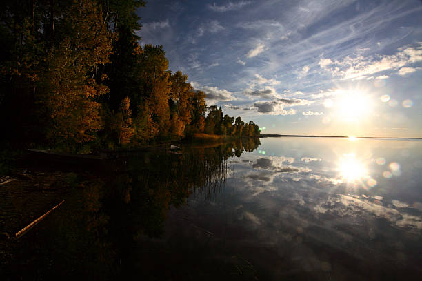 Sun rising over a Saskatchewan lake stock photo