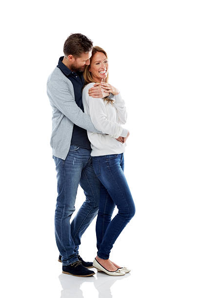 istock Loving mature couple standing together over white 501292473
