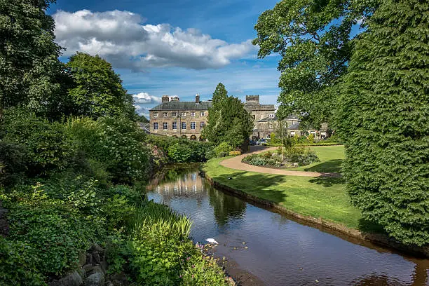 Picturesque view of typical stone buildings in Buxton from the park gardens.