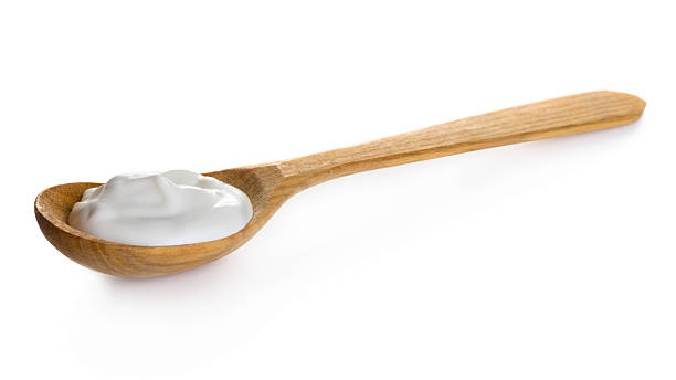 istock Cream in wooden spoon 501293136