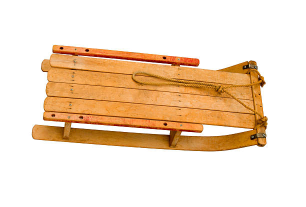 Decorations of ski with poles and a sleigh and skates on real snow.