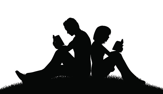 Editable vector silhouette of a couple sitting outside reading with figures as separate objects