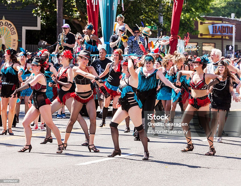 Dance Troupe Performs In Parade Seattle, United States - June 21, 2014: A performance dance troupe wearing cabaret costumes performs in the 2014 Annual Fremont Summer Solstice Day Parade in Seattle on June 21, 2014. The parade celebrates the start of summer. 2014 Stock Photo