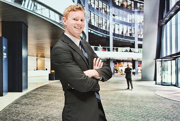 istock Smiling businessman standing with arms crossed 501296484