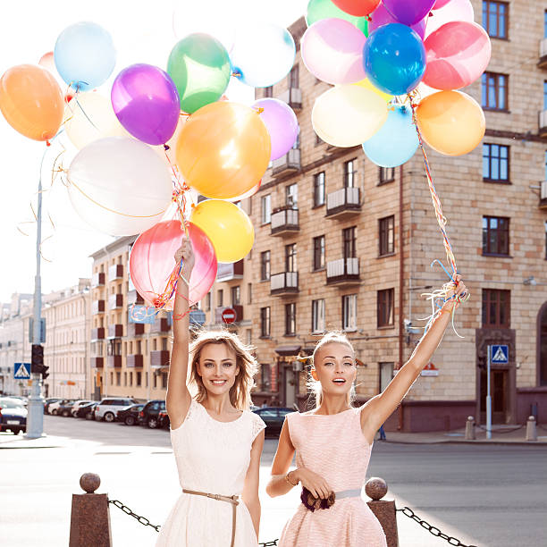 istock two beautiful ladys in retro outfit holding balloons 501297655