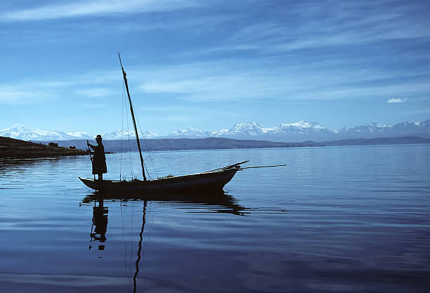 Lake Titicaca, Bolivia – February 3, 2007: Fisherman and boat on Lake Titicaca in the early morning. 