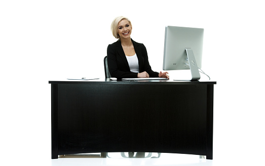 Smiling businesswoman sitting and workinghttp://www.twodozendesign.info/i/1.png