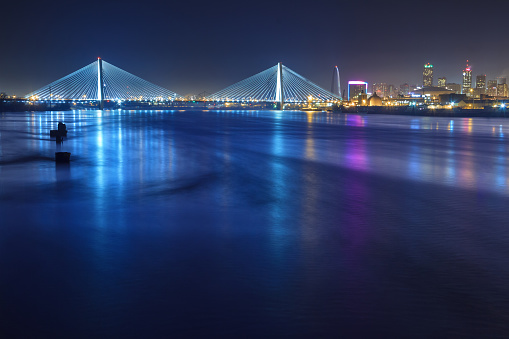 A view of St. Louis Missouri at night with the river and bridges included.