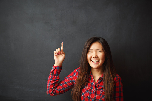 Young asian woman idea on blackboard.