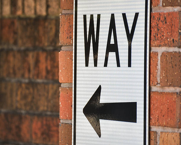 istock Sign with Arrow on Brick Wall - Color Version 501334422