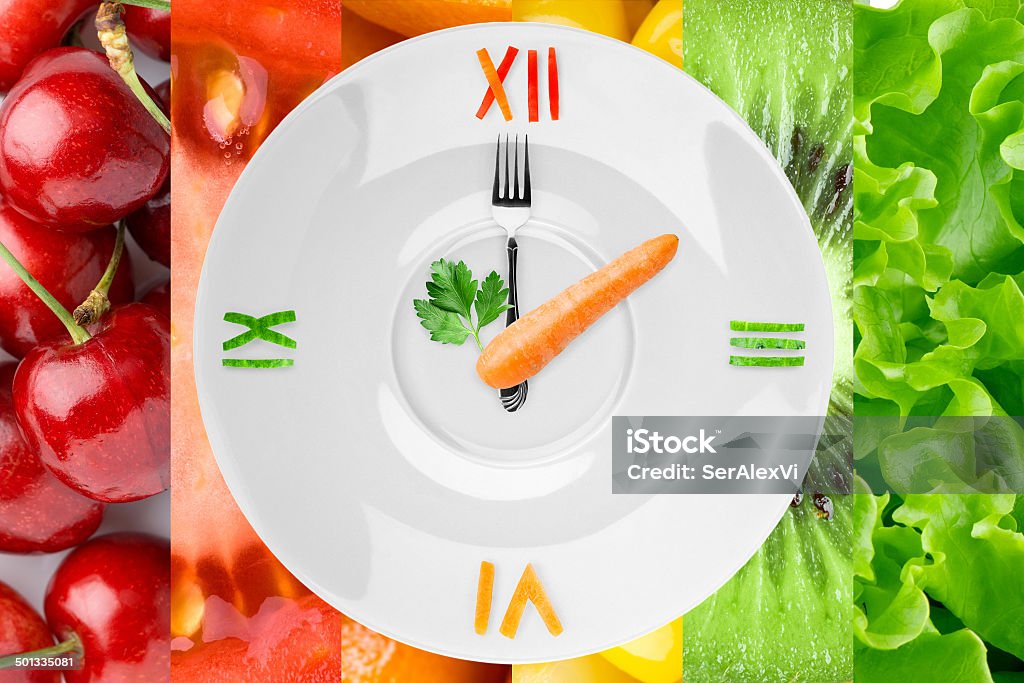 Food clock with vegetables and fruits Food clock with vegetables and fruits as background. Healthy food concept Backgrounds Stock Photo