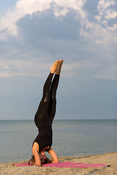 istock Beautiful lady doing yoga on the beach 501335291