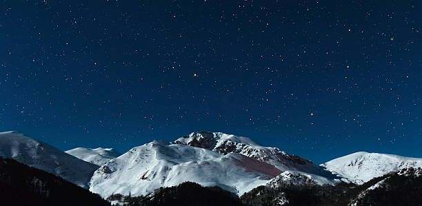 istock the mountain in moonlight and stars sky 501338021