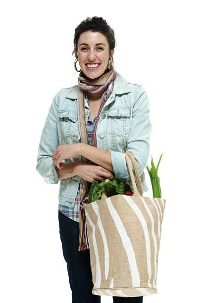 istock Cheerful woman holding vegetable bag 501339379