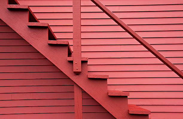 Red stairs of the red barn Close up on red stairs of the red building. red barn house stock pictures, royalty-free photos & images