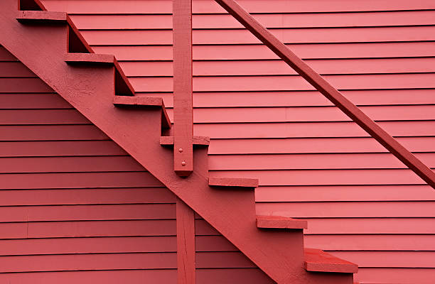 Red stairs of the red barn Close up on red stairs of the red building. monochrome house stock pictures, royalty-free photos & images