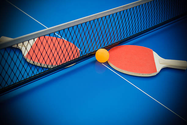 istock pingpong rackets and ball highlighted on a blue pingpong table 501341336