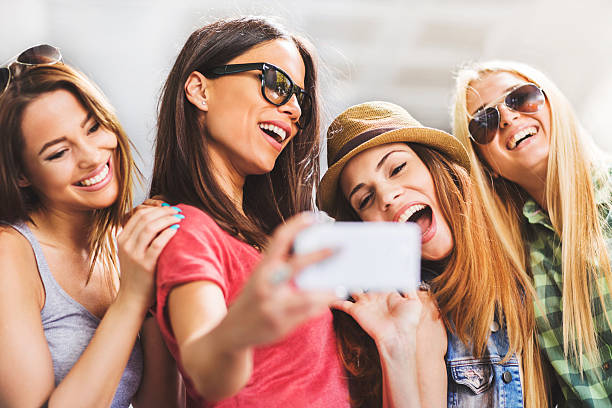 istock Happy women having fun while taking a selfie with phone. 501354674