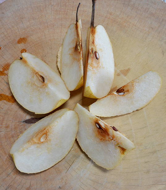 istock Chinese pear cut on wooden chop block 501361092