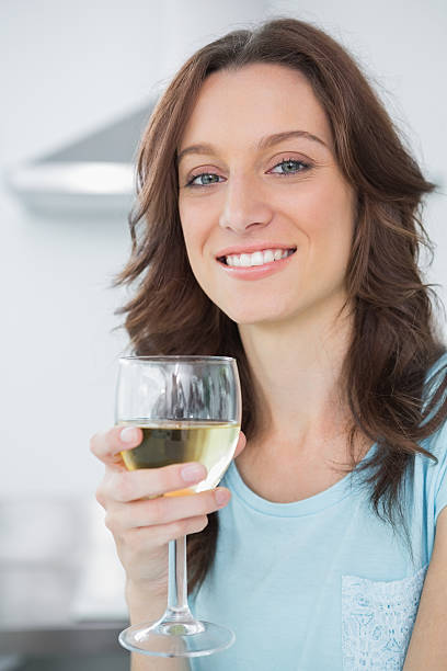 istock Brunette having a glass of white wine 501362105