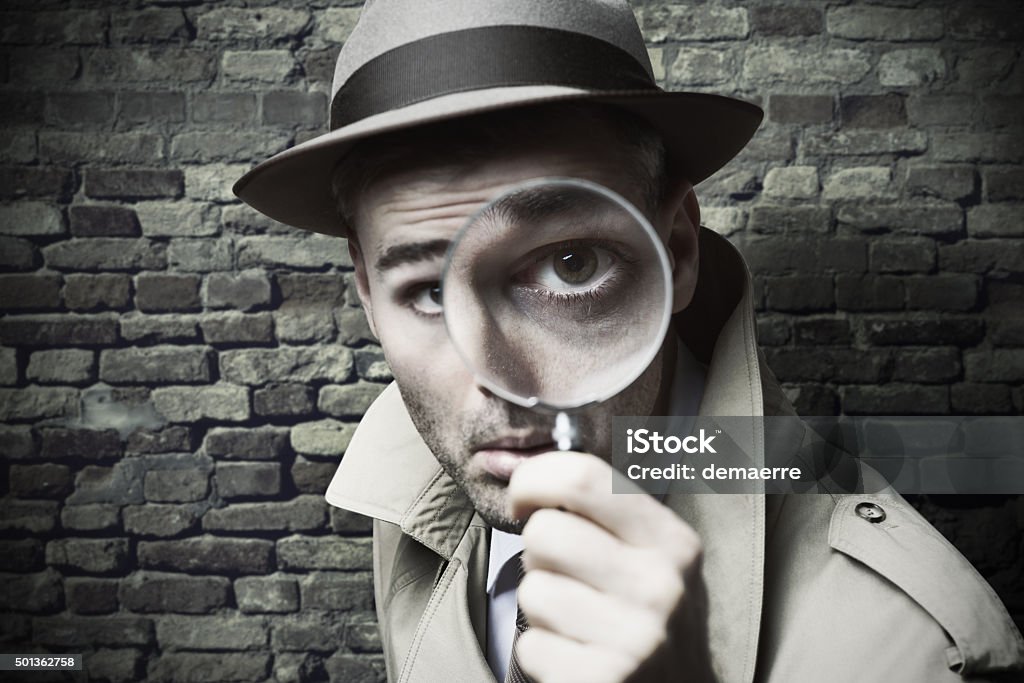 Vintage detective looking through a magnifier Funny vintage detective looking through a magnifier Detective Stock Photo