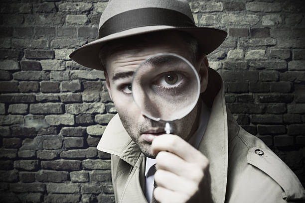 Vintage detective looking through a magnifier Funny vintage detective looking through a magnifier detective stock pictures, royalty-free photos & images