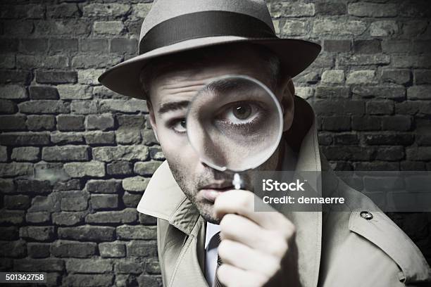 Vintage Detective Looking Through A Magnifier Stock Photo - Download Image Now - Detective, Magnifying Glass, Surveillance