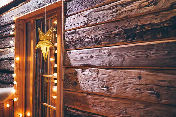Photo of Christmas decoration on wooden cabin