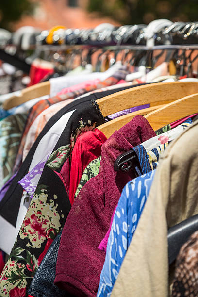 istock clothes on a rack on a flea market 501364109