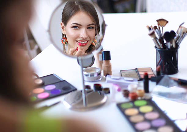 istock Young beautiful woman making make-up near mirror,sitting at 501365834