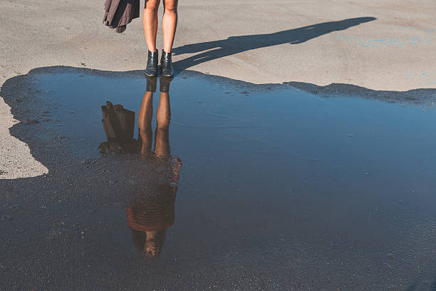 istock Puddle reflecting a beautiful girl posing in an urban context 501366510