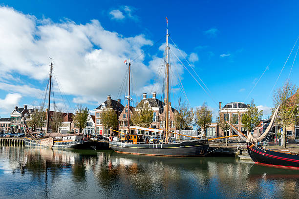 boats in  canal in Harlingen, Friesland, Netherlands old sail boats in a canal in Harlingen. friesland netherlands stock pictures, royalty-free photos & images