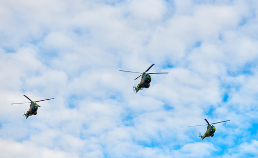 Two military helicopter flying.