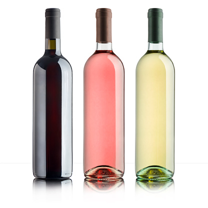 bottles with variety of wines, on white background