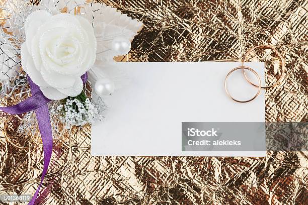 Rings Flowers And Invitation On A Gold Background Stock Photo - Download Image Now