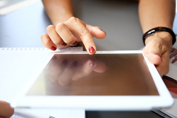 istock Business person analyzing financial statistics displayed on the tablet screen 501385794