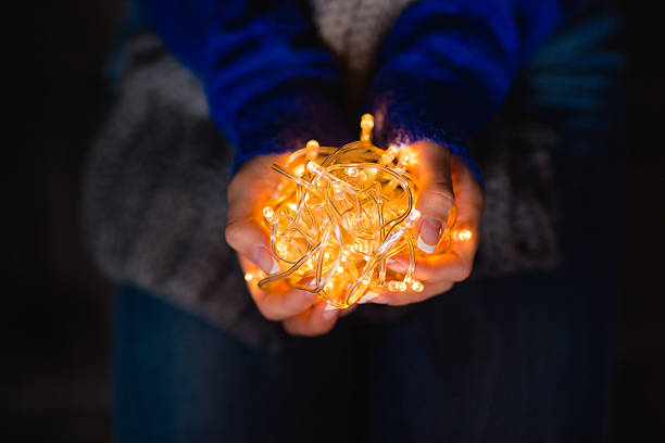 istock Female hands holding holidays lights 501386698