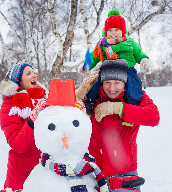 istock Family with a snowman 501388242