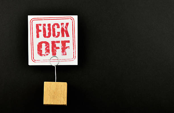 istock Fuck off paper note with holder on black background 501391520