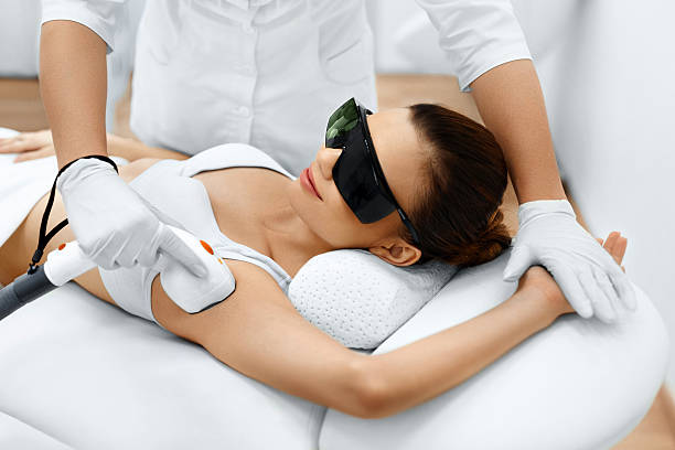 Body Care. Laser Hair Removal. Epilation Treatment. Smooth Skin. Body Care. Underarm Laser Hair Removal. Beautician Removing Hair Of Young Woman's Armpit. Laser Epilation Treatment In Cosmetic Beauty Clinic.  hairless animal photos stock pictures, royalty-free photos & images
