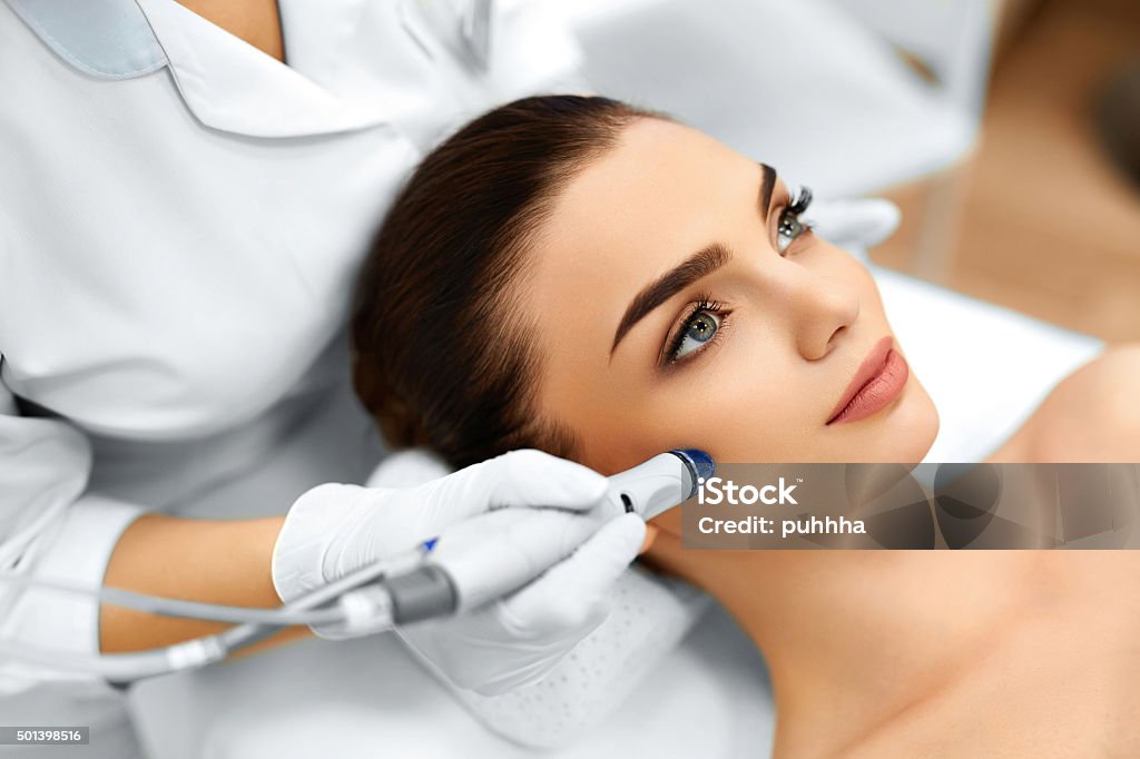 Face Skin Care. Facial Hydro Microdermabrasion Peeling Treatment Face Skin Care. Close-up Of Woman Getting Facial Hydro Microdermabrasion Peeling Treatment At Cosmetic Beauty Spa Clinic. Hydra Vacuum Cleaner. Exfoliation, Rejuvenation And Hydratation. Cosmetology. Beauty Product Stock Photo