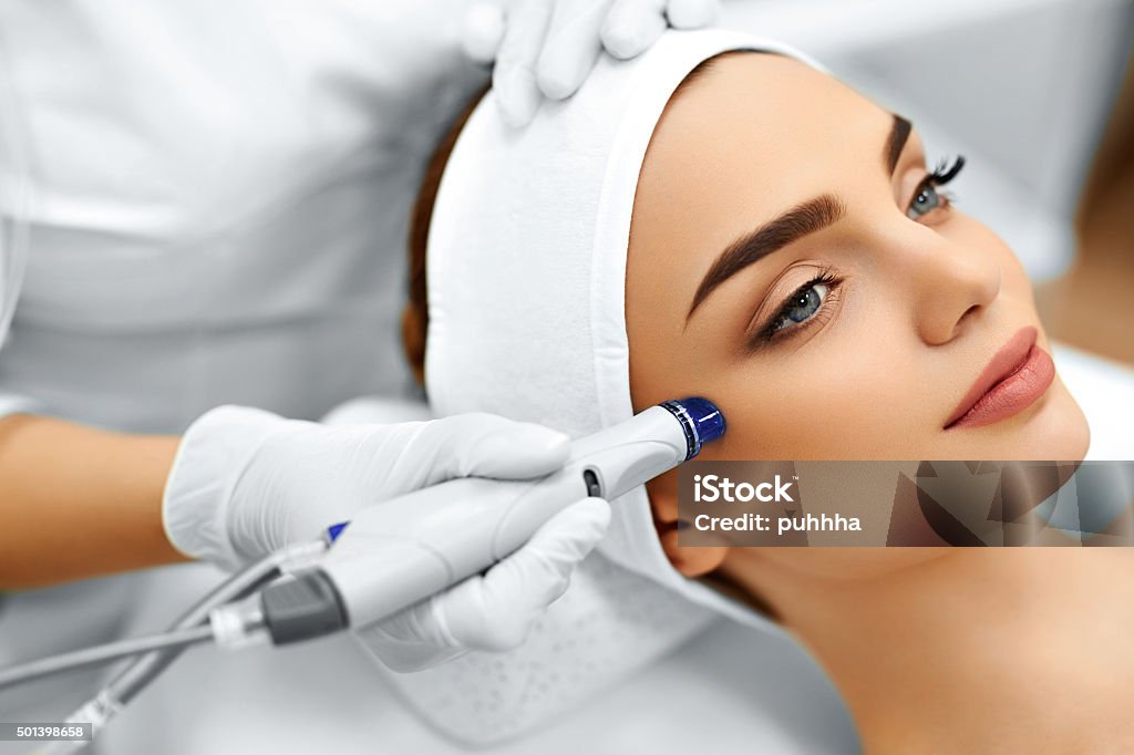Face Skin Care. Facial Hydro Microdermabrasion Peeling Treatment Face Skin Care. Close-up Of Woman Getting Facial Hydro Microdermabrasion Peeling Treatment At Cosmetic Beauty Spa Clinic. Hydra Vacuum Cleaner. Exfoliation, Rejuvenation And Hydratation. Cosmetology. Microdermabrasion Stock Photo