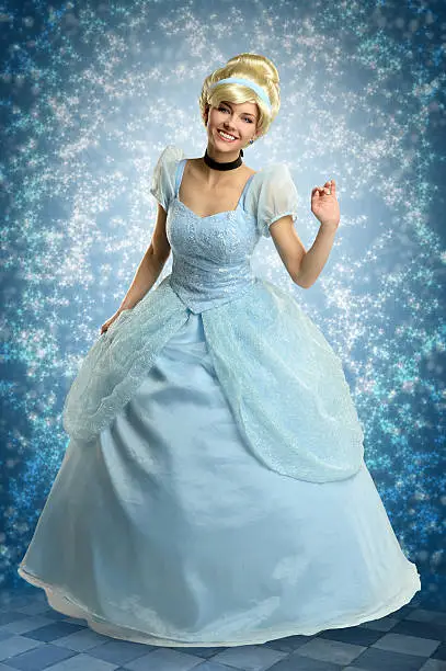 Portrait of beautiful woman dressed in princess costume over magical background